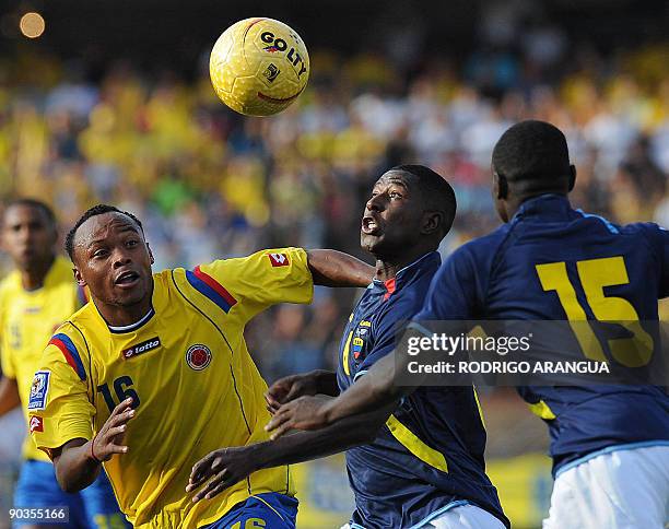 Colombia´s Juan Zuniga vies for the ball with Ecuador´s Edison Mendez as teammate Walter Ayovi looks on during their FIFA World Cup South Africa 2010...