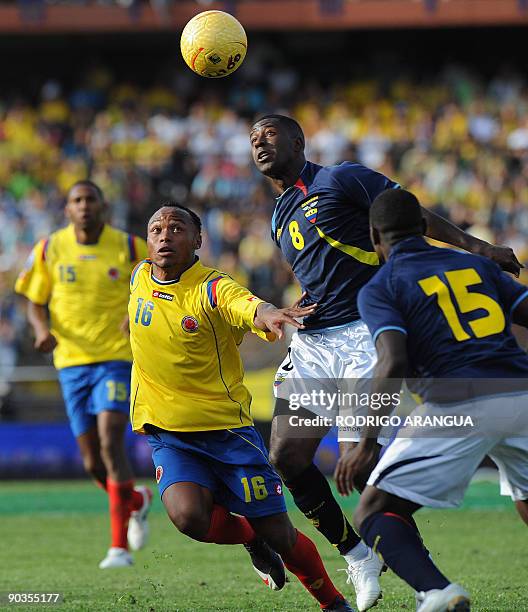 Colombia´s Juan Zuniga vies for the ball with Ecuador´s Edison Mendez as teammate Walter Ayovi looks on during their FIFA World Cup South Africa 2010...