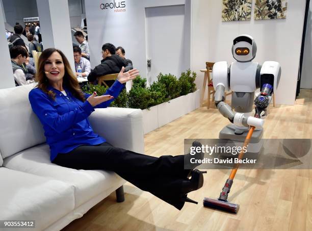 Aeolus representative Cindy Ferda demostrates the Aeolus Robot's abilities at the Aeolus booth during CES 2018 at the Las Vegas Convention Center on...