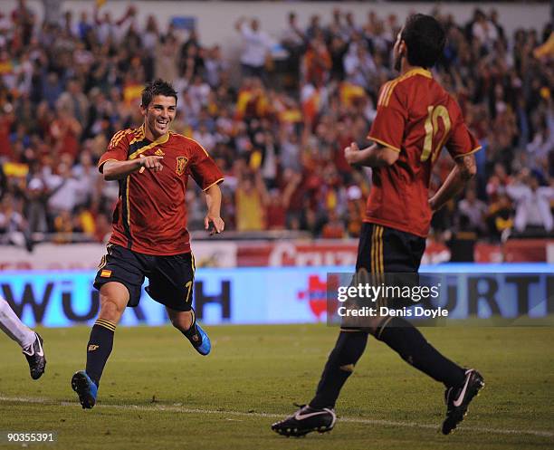 David Villa of Spain celebrates with Cesc Fabregas after scoring Spain's fourth goal during the Group 5 FIFA2010 World Cup Qualifier match between...