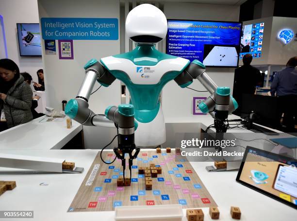 An intelligent vision robot plays Scrabble at the Industrial Technology Research Institute booth during CES 2018 at the Las Vegas Convention Center...