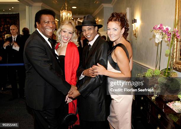 Singer Roberto Blanco, his girlfriend Luzandra Strassburg, singer Marla Glen and wife Sabrina Conley attend the 'UNICEF-Gala' at Park Hotel on...