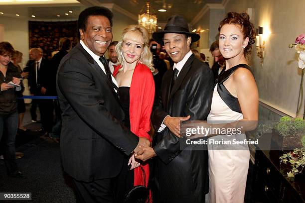 Singer Roberto Blanco, his girlfriend Luzandra Strassburg, singer Marla Glen and wife Sabrina Conley attend the 'UNICEF-Gala' at Park Hotel on...