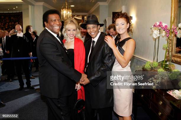 Singer Roberto Blanco, his girlfriend Luzandra Strassburg, singer Marla Glen and wife Sabrina Conley attend the 'UNICEF-Gala' at Park Hotel on...