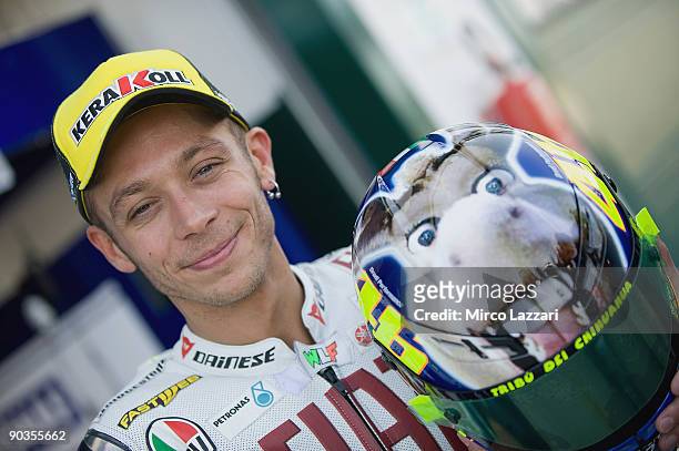 Valentino Rossi of Italy and Fiat Yamaha Team poses with the new helmet before the qualifying practice of the Gran Premio Cinzano di San Marino e...