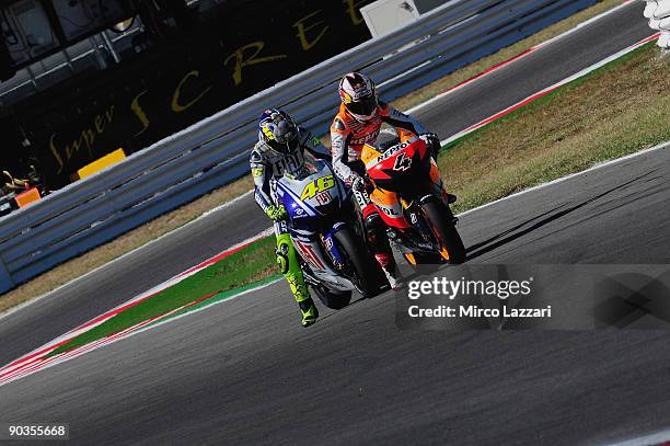 Andrea Dovizioso of Italy and Repsol Honda Team and Valentino Rossi of Italy and Fiat Yamaha Team try the start after the qualifying practice of the...