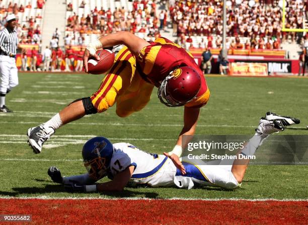 Tight end Rhett Ellison of the USC Trojans dives for a touchdown over safety Tanner Burns of the San Jose State Spartans on September 5, 2009 at the...