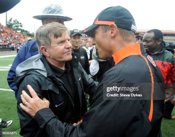 Head coach Jerry Glanville of the Portland State Vikings shakes hands with head coach Mike Riley of the Oregon State Beavers after the game at Reser...