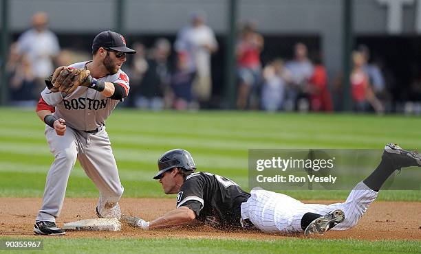 Scott Podsednik of the Chicago White Sox steals second base under the late tag by Dustin Pedrioa of the Boston Red Sox on September 5, 2009 at U.S....