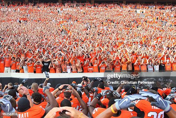 The Oklahoma State Cowboys sing their school's Alma Mater with fans after their 24-10 victory over the Georgia Bulldogs at Boone Pickens Stadium on...