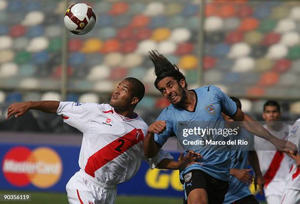 Alberto Rodriguez of Peru vies for the ball with Jorge Martinez of Uruguay during their FIFA World Cup 2010 Qualifier at Monumental Stadium on...