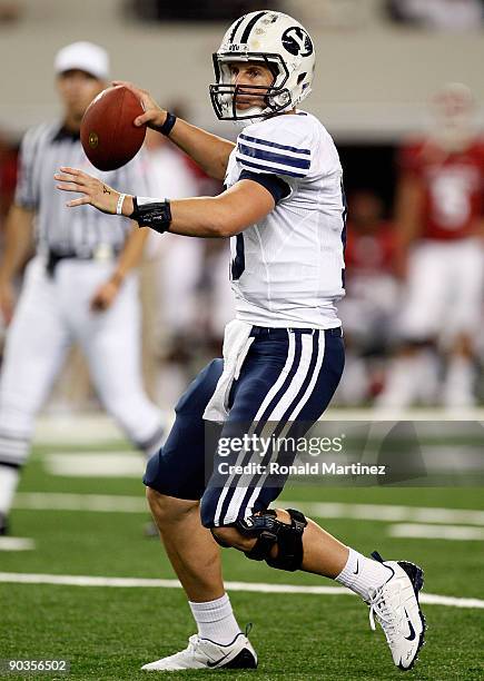 Quarterback Max Hall of the Brigham Young Cougars drops back to pass against the Oklahoma Sooners at Cowboys Stadium on September 5, 2009 in...