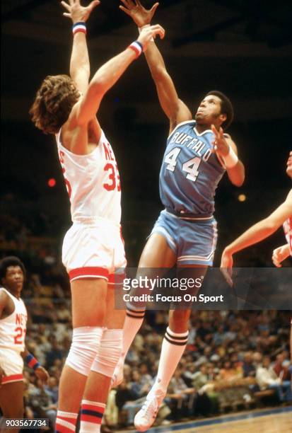 Adrian Dantley of the Buffalo Braves shoots over Kim Hughes of the New Jersey Nets during an NBA basketball game circa 1977 at the Rutgers Athletic...