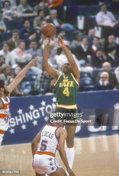 Adrian Dantley of the Utah Jazz shoots over Greg Ballard of the Washington Bullets during an NBA basketball game circa 1981 at the Capital Centre in...