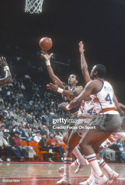 Adrian Dantley of the Utah Jazz shoots over Greg Ballard of the Washington Bullets during an NBA basketball game circa 1984 at the Capital Centre in...