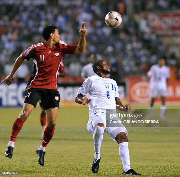Honduran Jerry Palacios vies for the ball with the Trinidad and Tobago's Carlos Edwards during their FIFA World Cup South Africa-2010 qualifier...