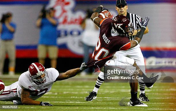 Cornerback Jayron Hosley of the Virginia Tech Hokies breaks a tackle by Eryk Anders of the Alabama Crimson Tide during the Chick-fil-A Kickoff Game...