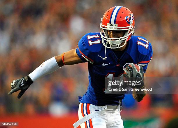 Riley Cooper of the Florida Gators runs for yardage during the game against the Charleston Southern Buccaneers at Ben Hill Griffin Stadium on...