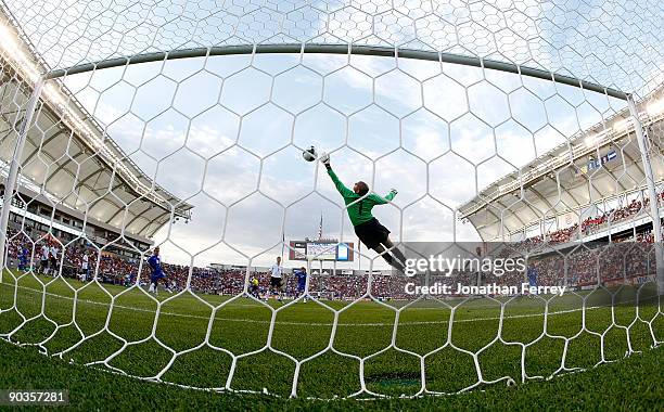 Goalkeeper Tim Howard of the United States stretches attempts to reach a goal strike by Christian Castillo of ElSalvador in the first half during the...