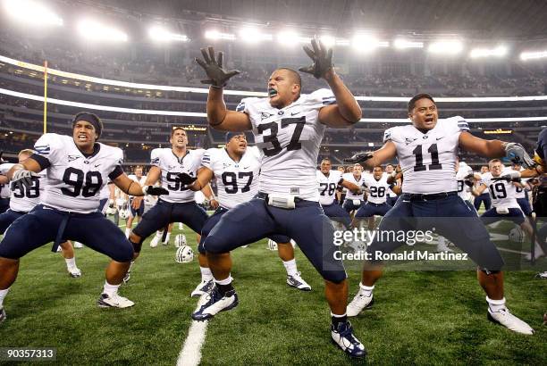 Romney Fuga, Vic So'oto and Manase Tonga of the Brigham Young Cougars celebrate a 14-13 win against the Oklahoma Sooners at Cowboys Stadium on...