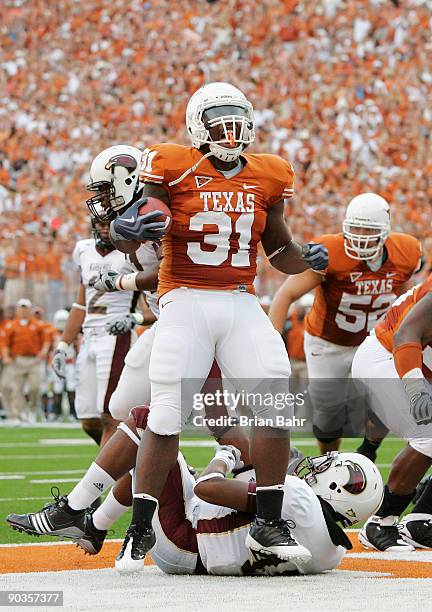 Running back Cody Johnson of the Texas Longhorns celebrates after scoring his first touchdown against of the Louisiana Monroe Warhawks in the first...