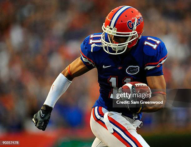 Riley Cooper of the Florida Gators runs for yardage during the game against the Charleston Southern Buccaneers at Ben Hill Griffin Stadium on...