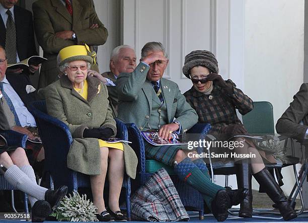 Queen Elizabeth II, Prince Charles, Prince of Wales and Princess Anne, Princess Royal watch the events at the 2009 Braemar Highland Games on...