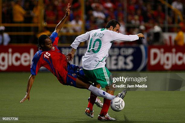 Mexico's Cuauhtemoc Blanco vies for the ball with Junior Diaz of Costa Rica during their FIFA 2010 World Cup qualifier at the Ricardo Saprissa...