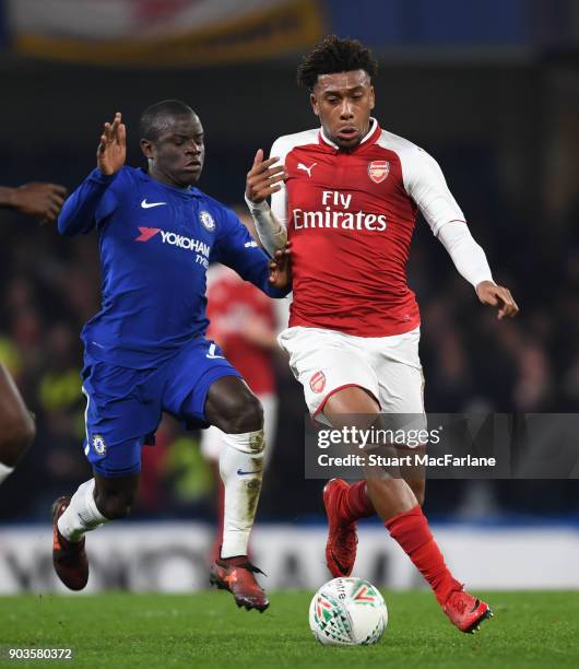 Alex Iwobi of Arsenal takes on N'Golo Kante of Chelsea during the Carabao Cup Semi-Final First Leg match between Chelsea and Arsenal at Stamford...
