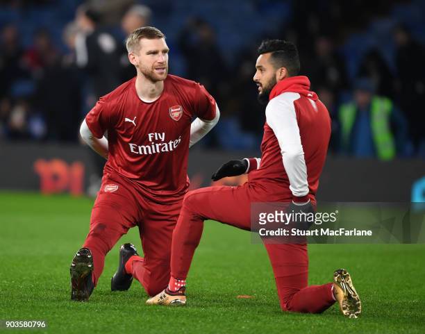 Per Mertesacker and Theo Walcott of Arsenal before the Carabao Cup Semi-Final First Leg match between Chelsea and Arsenal at Stamford Bridge on...