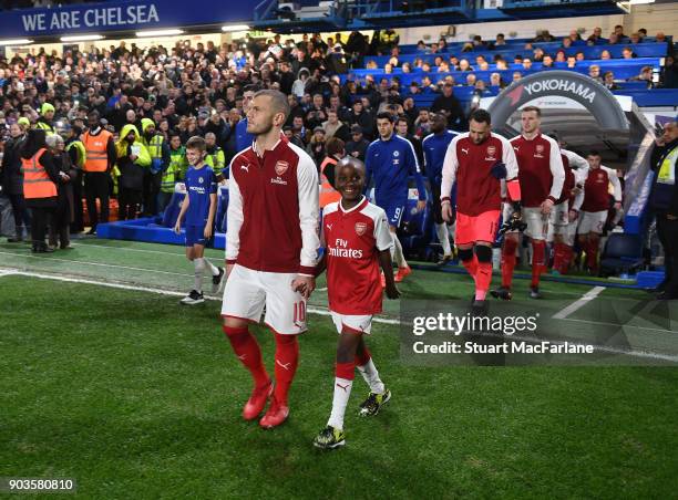 Arsenal captain Jack Wilshere leads out his team before the Carabao Cup Semi-Final First Leg match between Chelsea and Arsenal at Stamford Bridge on...