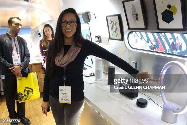 Monika Chalk of the Amazon Alexa team demonstrates an array of devices infused the company's artificial intelligence in a Roadshow trailer parked at...