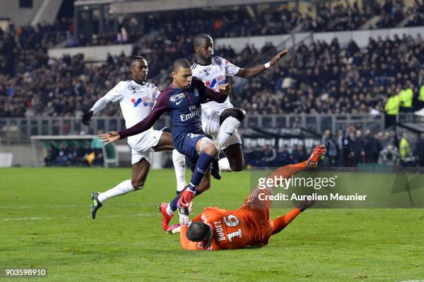 Kylian Mbappe of Paris Saint-Germain is stopped by Amien goalkeeper Jean-Christophe Bouet during the League cup match between Amiens and Paris Saint...