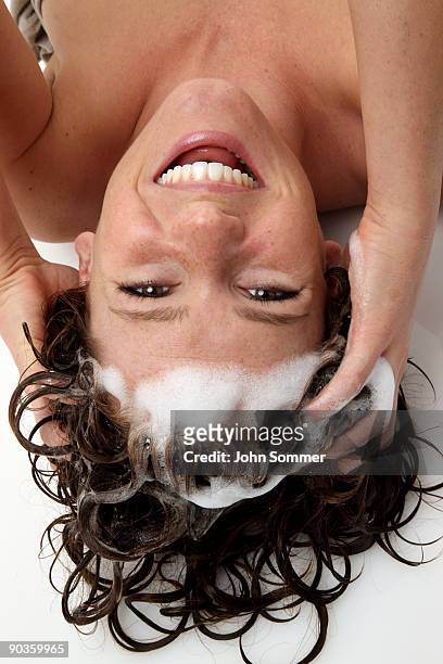 cute girl shampooing her hair - women washing hair stock pictures, royalty-free photos & images