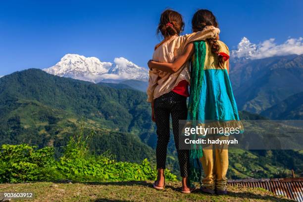 nepali little girls looking at annapurna south - nepal stock pictures, royalty-free photos & images