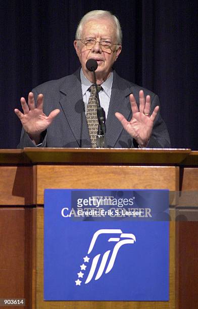 Former U.S. President Jimmy Carter addresses attendees February 21, 2002 during the Development Cooperation Forum at the Carter Center in Atlanta,...