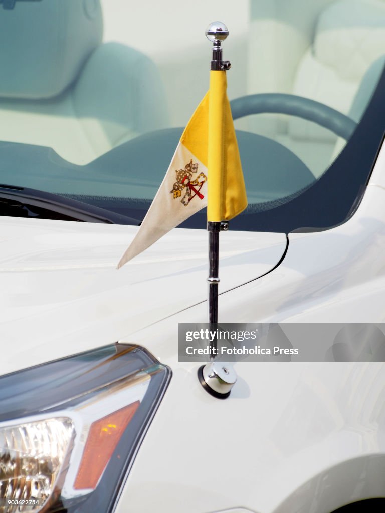The Vatican flag on the Popemobile, a modified Chevrolet...