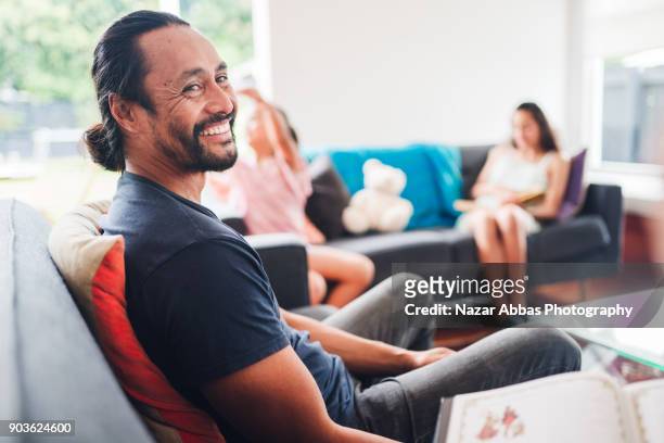parent talking each other while kids sitting on sofa playing. - good family couple stock pictures, royalty-free photos & images