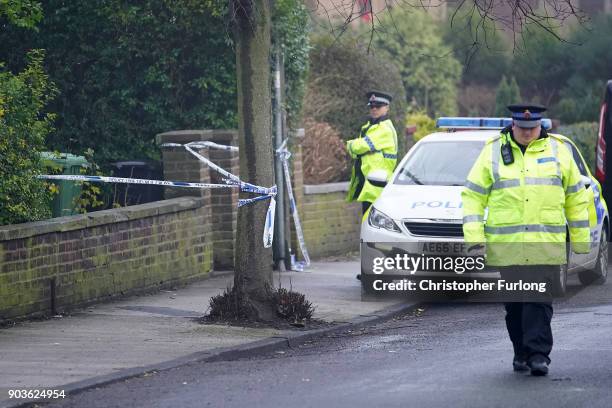 Forensic technicians work outside a home in Matlock Road, Reddish, after a body was found in a back garden on January 10, 2018 in Stockport, England....