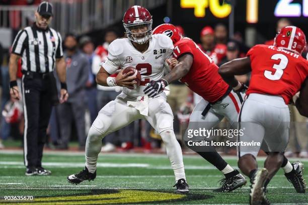 Alabama Crimson Tide quarterback Jalen Hurts is tackled by Georgia Bulldogs linebacker Davin Bellamy during the College Football Playoff National...