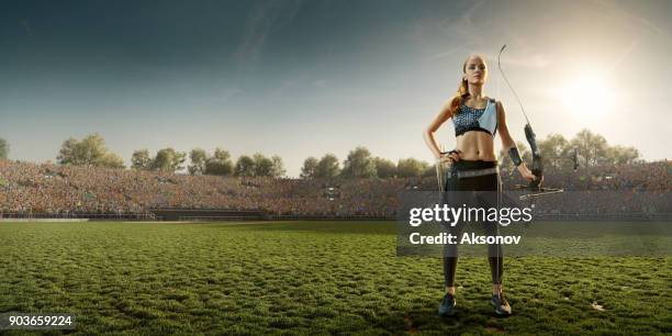 female archer shooting with the longbow at sunset - arco e flecha equipamento desportivo imagens e fotografias de stock