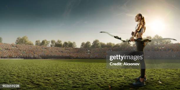 female archer shooting with the longbow at sunset - archery range stock pictures, royalty-free photos & images