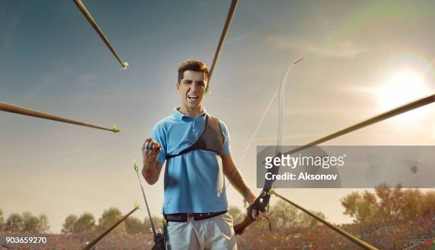male archer rejoices in victory in professional field - archery range stock pictures, royalty-free photos & images