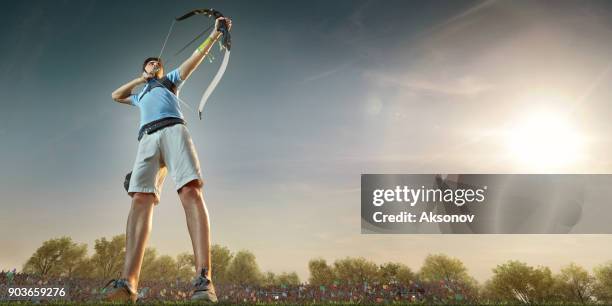 male archer shooting with the longbow at sunset - audience targeting stock pictures, royalty-free photos & images