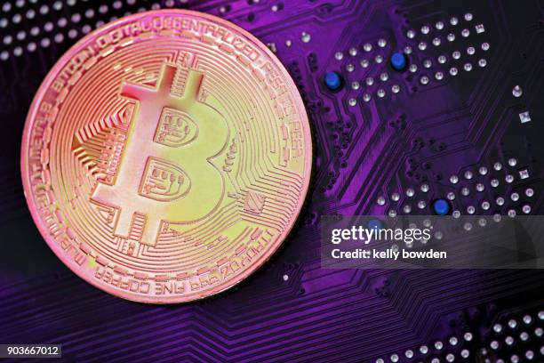 ultraviolet cryptocurrency bitcoin on mother board - kelly bowden stockfoto's en -beelden
