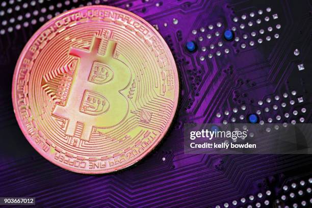 ultraviolet cryptocurrency bitcoin on mother board - kelly bowden stock pictures, royalty-free photos & images