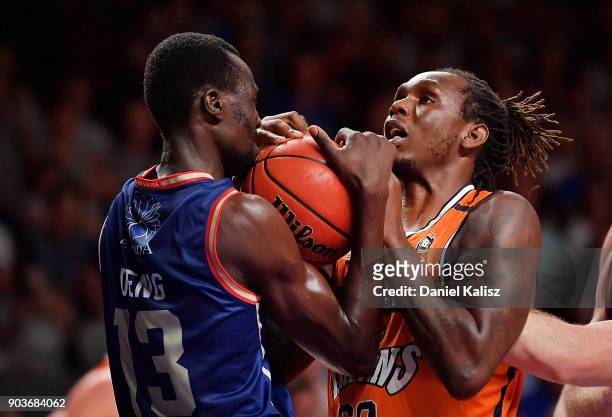 Majok Deng of the Adelaide 36ers competes for the ball with Jerry Evans Jnr of the Taipans during the round 14 NBL match between the Adelaide 36ers...