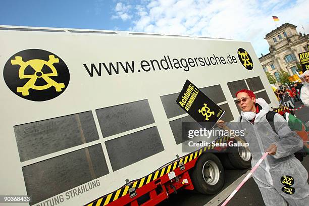 Anti-nuclear protesters accompanying a mock-Castor nuclear waste transport walk past the Reichstag during an anti-nuclear energy demonstration on...