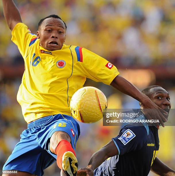 Colombia's Juan Zuniga and Ecuador's Walter Ayovi vie for the ball during a FIFA World Cup South Africa 2010 qualifier football match at the Atanasio...