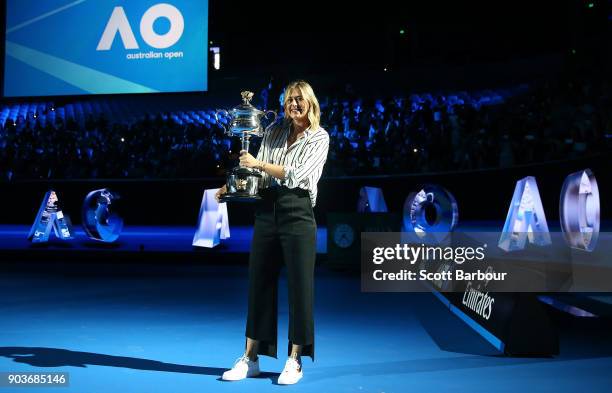 Maria Sharapova of Russia arrives on court with the the Daphne Akhurst Trophy during the 2018 Australian Open Official Draw at Melbourne Park on...